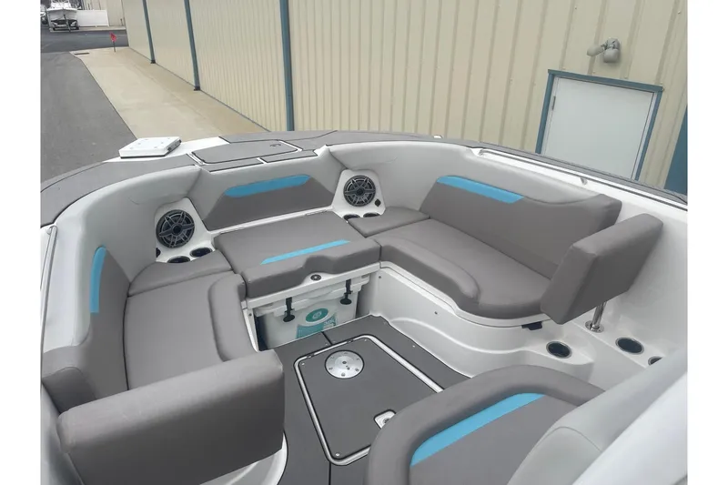 Slide: The Image of 2025 Hurricane Center Console 24 OB boat interior with gray seating and built-in speakers. - 40