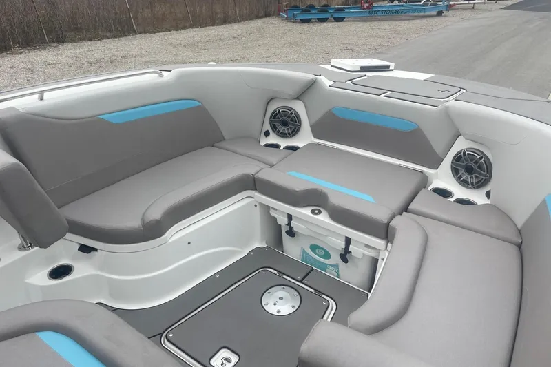 Slide: The Image of 2025 Hurricane Center Console 24 OB boat interior with gray seating and blue accents. - 41