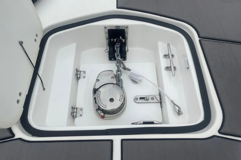 Slide: The Image of Anchor compartment of 2025 Hurricane Center Console 24 OB boat, featuring a secure chain mechanism. - 47