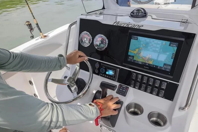 Slide: The Image of 2025 Hurricane Center Console 24 OB dashboard with navigation screen and controls. - 49