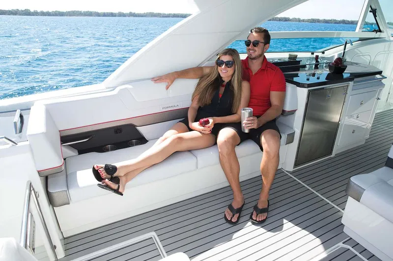 Slide: The Image of Manufacturer Provided Image: Couple relaxing on a 2018 Formula 430 Super Sport Crossover yacht. - 12