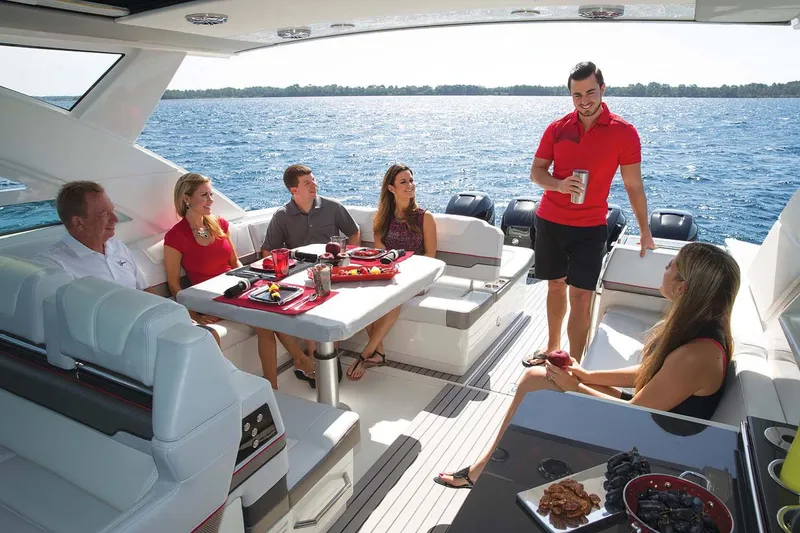 Slide: The Image of Manufacturer Provided Image: Group enjoying a meal on a 2018 Formula 430 Super Sport Crossover yacht. - 13