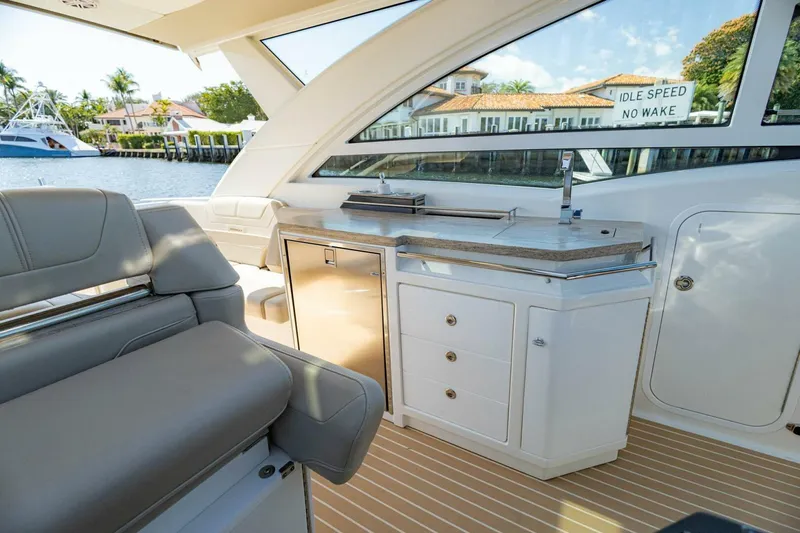 Slide: The Image of Interior of 2018 Formula 430 Super Sport Crossover yacht with sleek seating and kitchenette. - 23