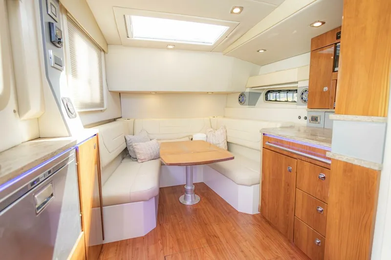 Slide: The Image of Interior of 2018 Formula 430 Super Sport Crossover with cozy seating and wooden cabinetry. - 24