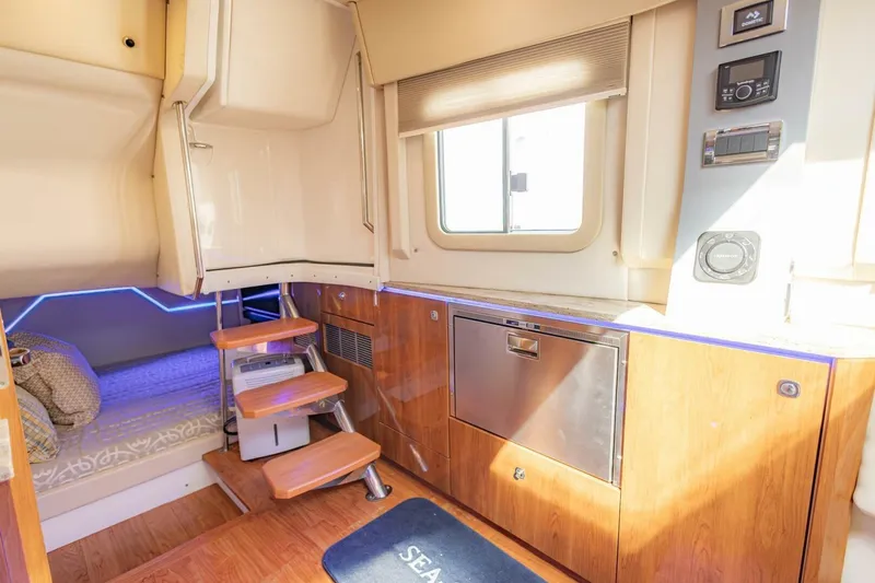 Slide: The Image of Interior of 2018 Formula 430 Super Sport Crossover with wooden cabinetry and modern amenities. - 26