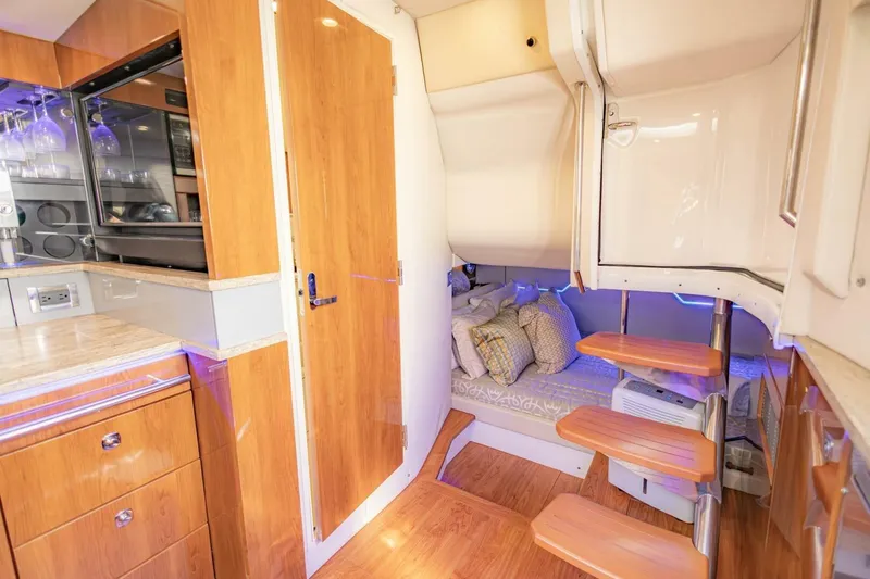 Slide: The Image of Interior of 2018 Formula 430 Super Sport Crossover with wooden cabinetry and cozy sleeping area. - 27