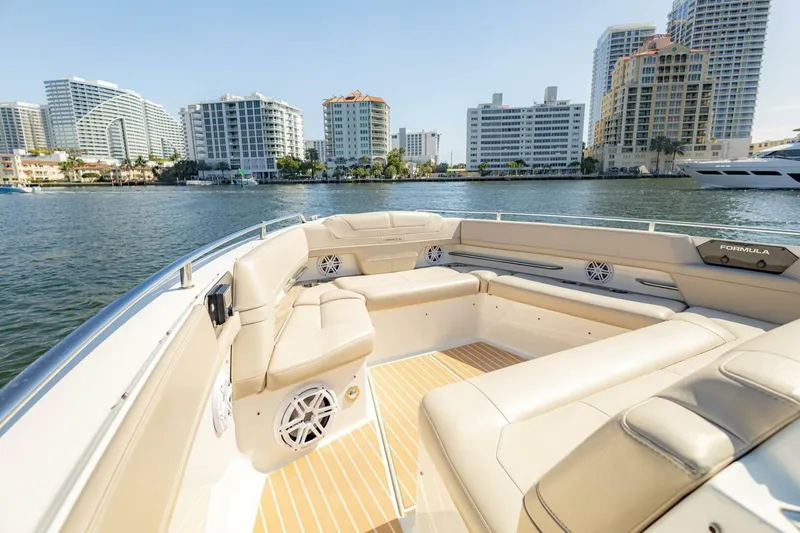 Slide: The Image of 2018 Formula 430 Super Sport Crossover boat with luxurious seating, city skyline in background. - 32