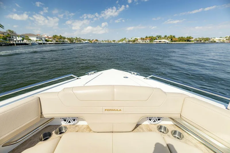 Slide: The Image of 2018 Formula 430 Super Sport Crossover boat cruising on a sunny waterway. - 35