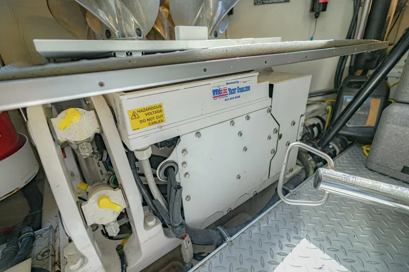 Slide: The Image of Engine room of 2018 Formula 430 Super Sport Crossover with electrical components and warning labels. - 43