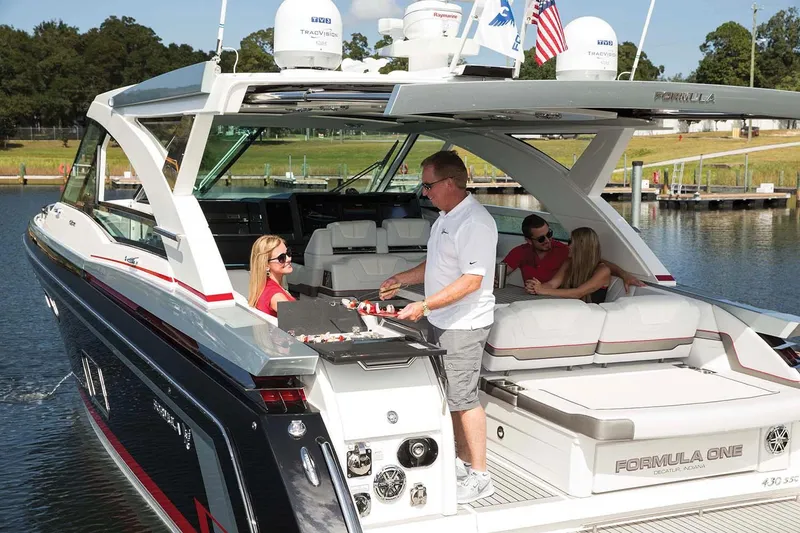 Slide: The Image of Manufacturer Provided Image: 2018 Formula 430 Super Sport Crossover yacht with people enjoying a barbecue on the deck. - 7