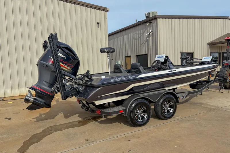 Slide: The Image of 2019 Skeeter ZX200 boat with Yamaha engine parked outside a building. - 10