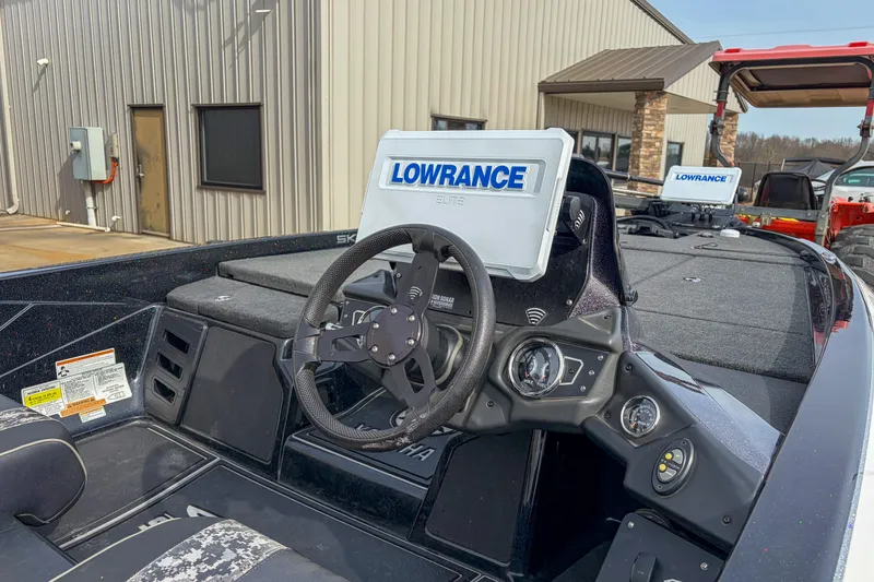 Slide: The Image of 2019 Skeeter ZX200 boat dashboard with Lowrance electronics, parked near a building. - 11