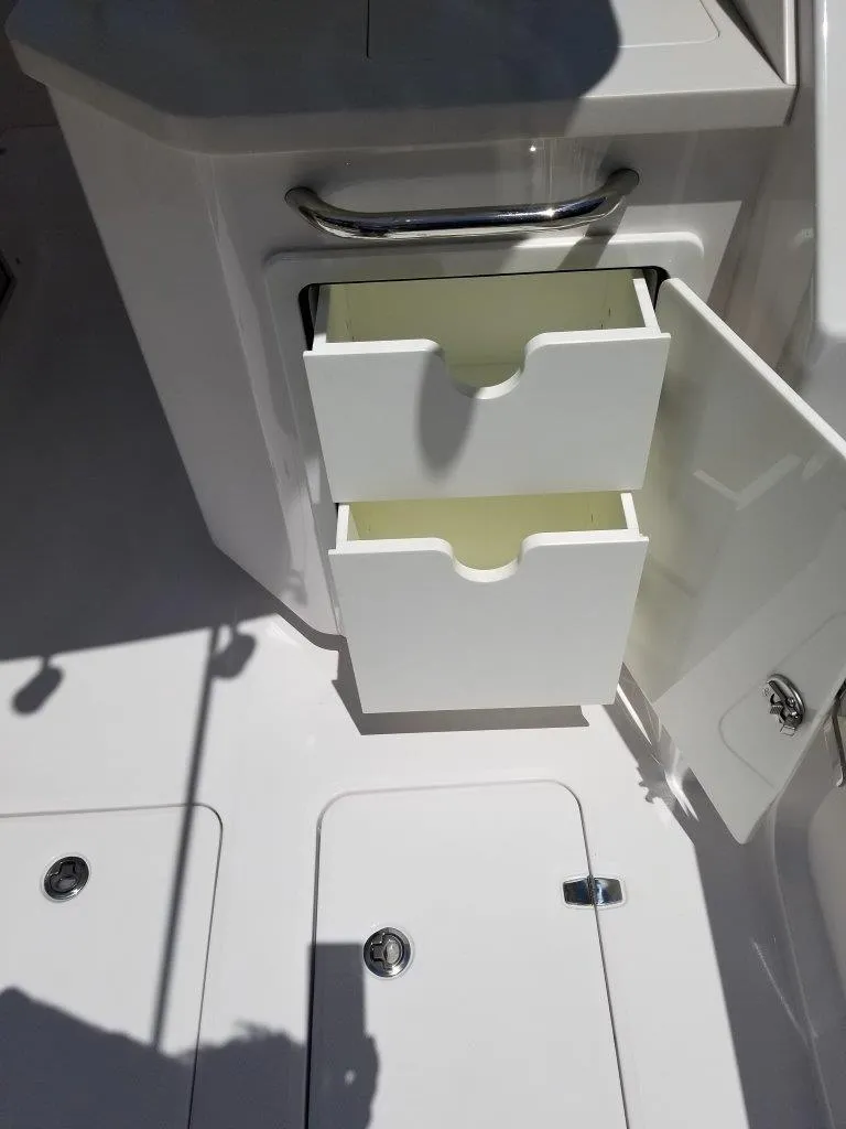 Slide: The Image of Open storage compartment on a 2021 Southport 33 DC boat. - 21