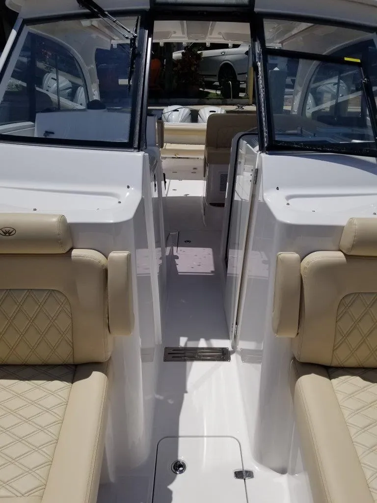 Slide: The Image of Interior of a 2021 Southport 33 DC boat with beige seating. - 9