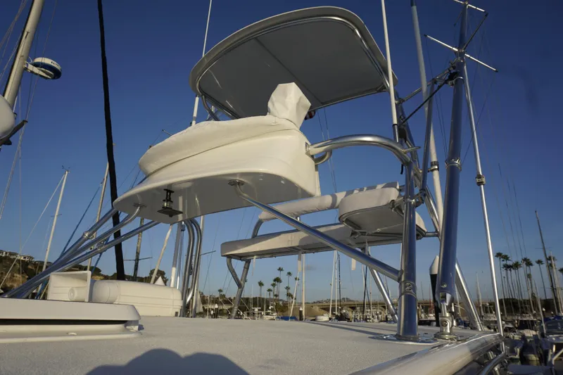 Slide: The Image of 2005 Cabo 35 Express boat with elevated seating and marina backdrop. - 10
