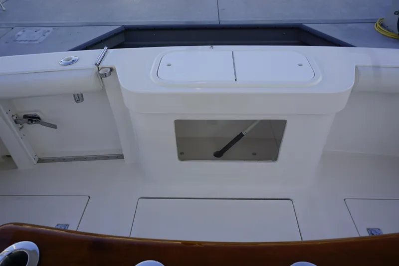 Slide: The Image of 2005 Cabo 35 Express boat deck with storage compartments and fishing rod holder. - 12