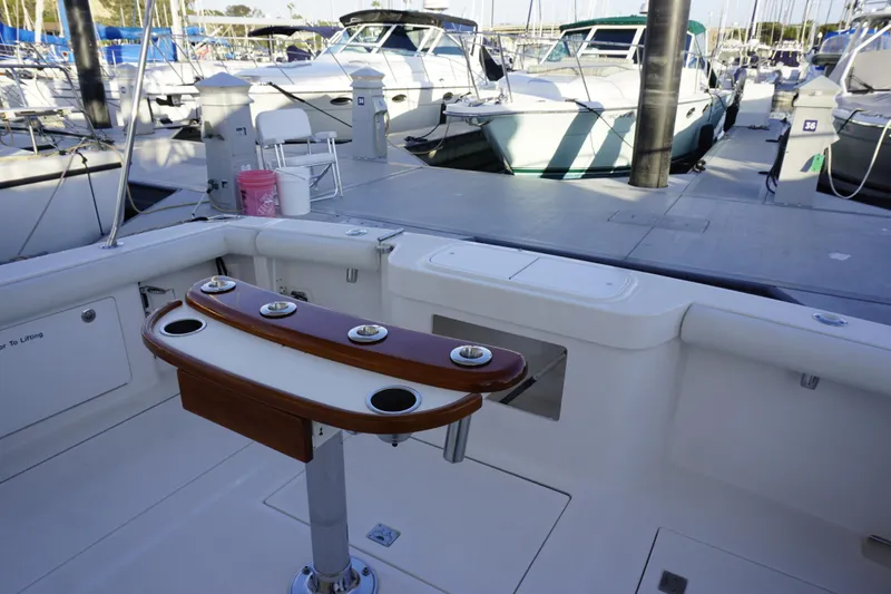 Slide: The Image of 2005 Cabo 35 Express boat interior with fishing rod holders at marina. - 13