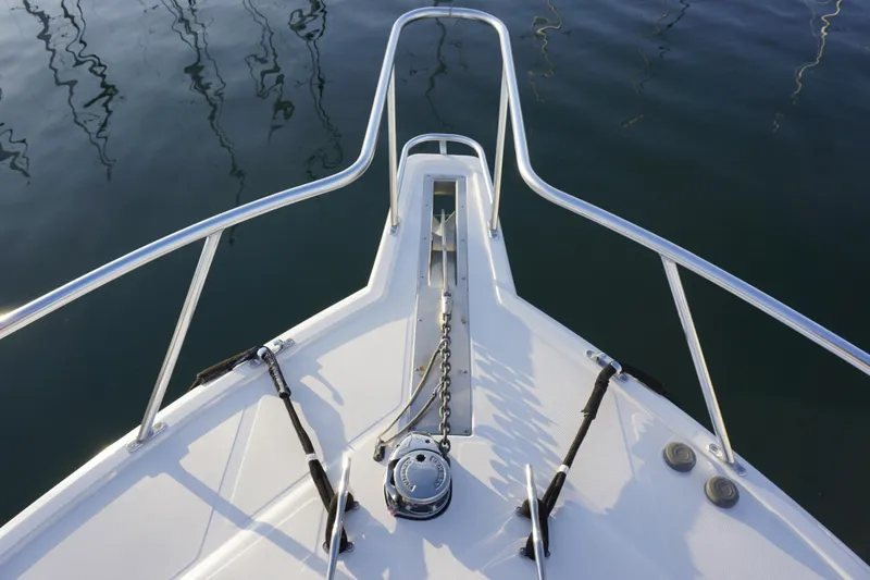 Slide: The Image of Bow of 2005 Cabo 35 Express boat with anchor chain and calm water reflection. - 15