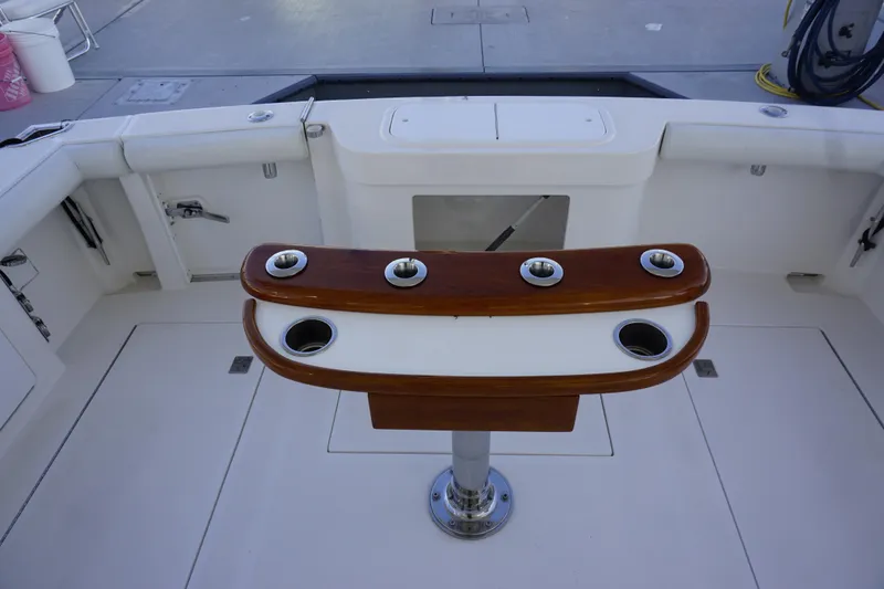 Slide: The Image of 2005 Cabo 35 Express boat cockpit with rod holders and clean deck. - 17