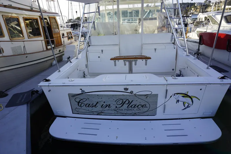 Slide: The Image of 2005 Cabo 35 Express boat docked, featuring "Cast in Place" signage at Dana Point, CA. - 18