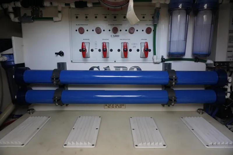 Slide: The Image of Electrical panel and filtration system in a 2005 Cabo 35 Express boat. - 26