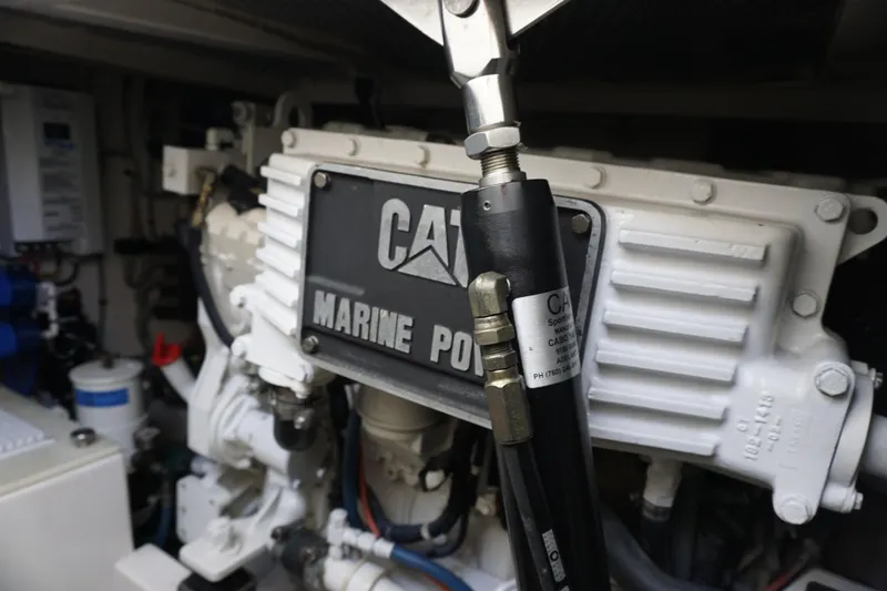 Slide: The Image of Engine compartment of a 2005 Cabo 35 Express boat, featuring CAT Marine Power components. - 28