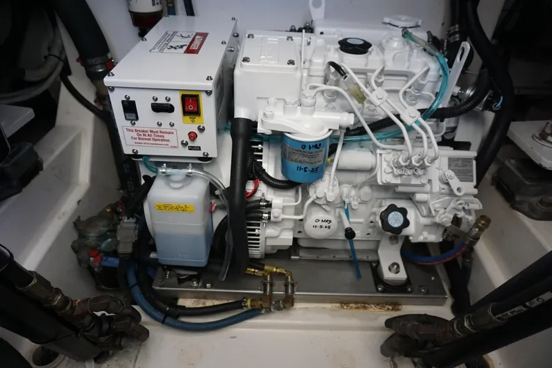 Slide: The Image of Engine compartment of a 2005 Cabo 35 Express boat, showcasing mechanical components and wiring. - 29