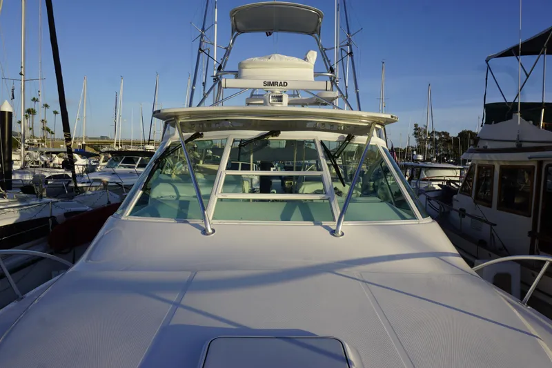 Slide: The Image of 2005 Cabo 35 Express boat docked in marina, surrounded by other vessels. - 8