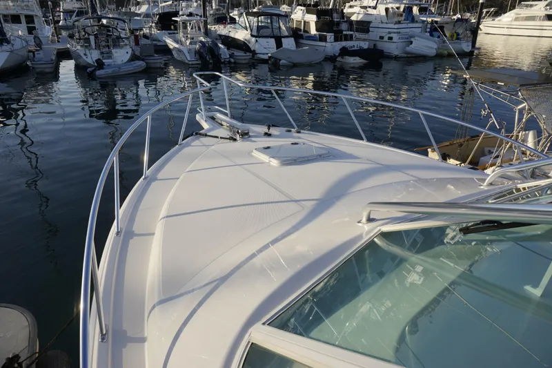 Slide: The Image of 2005 Cabo 35 Express yacht docked in a marina, surrounded by other boats. - 9