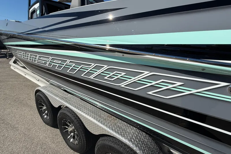 Slide: The Image of 2026 Sunsation 32 CCX boat on trailer, featuring sleek design and modern graphics. - 10