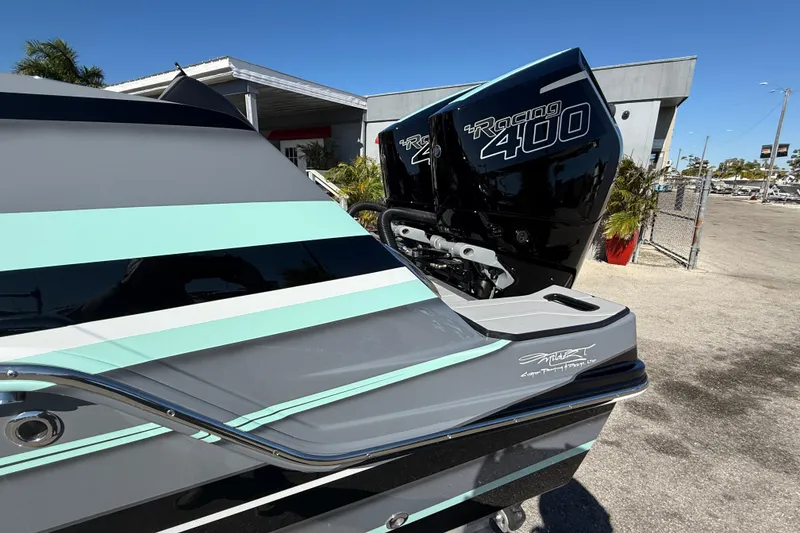 Slide: The Image of 2026 Sunsation 32 CCX boat with twin Racing 400 engines, sleek design, and vibrant stripes. - 11