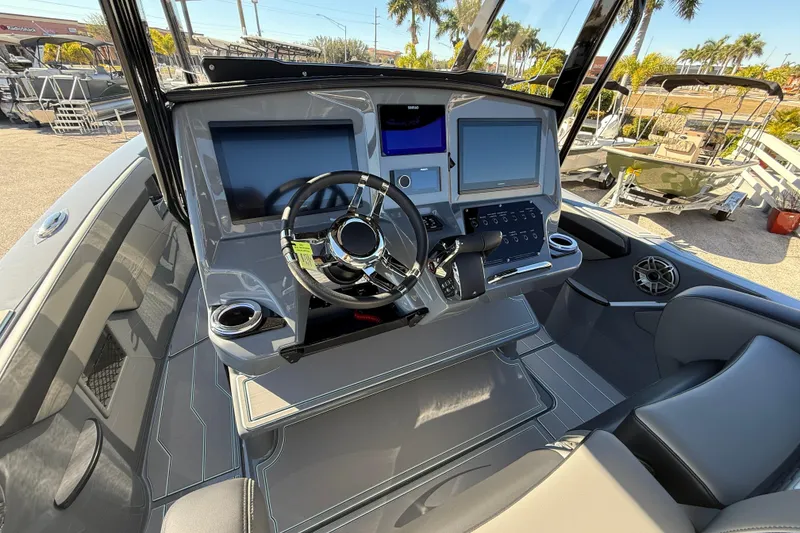 Slide: The Image of 2026 Sunsation 32 CCX boat cockpit with modern steering and dual screens. - 19
