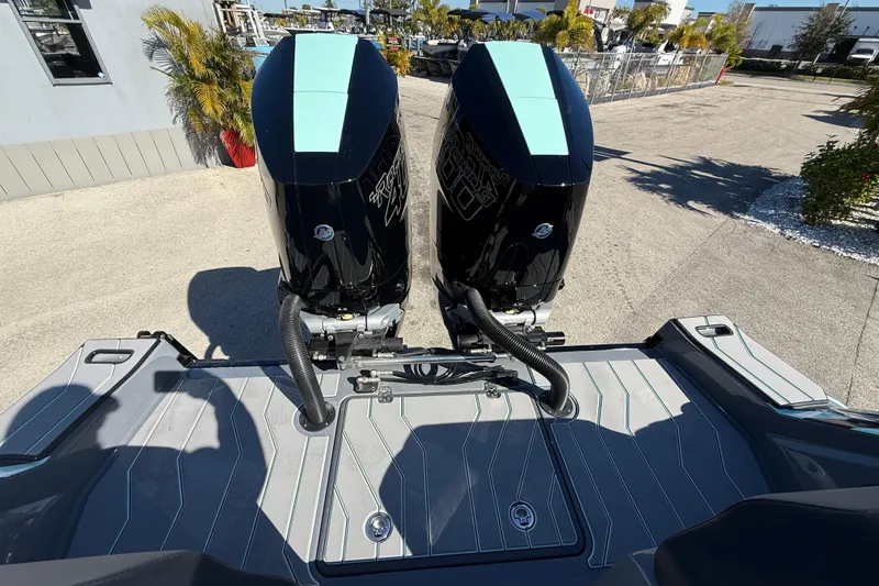 Slide: The Image of 2026 Sunsation 32 CCX boat with dual outboard engines, docked outdoors. - 22