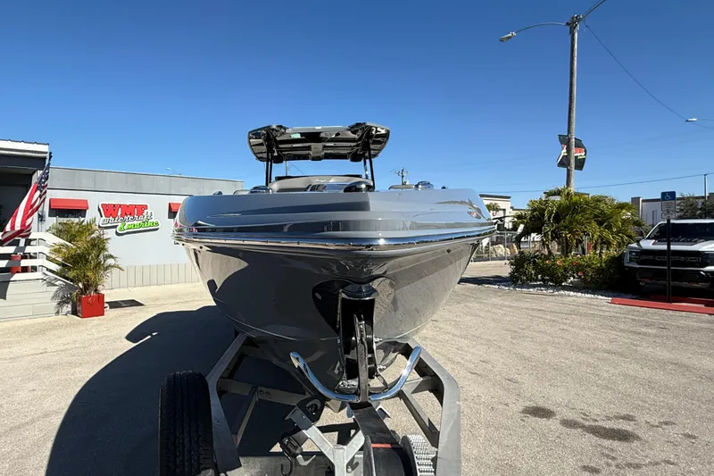 Slide: The Image of 2026 Sunsation 32 CCX boat on trailer at dealership, clear blue sky background. - 4