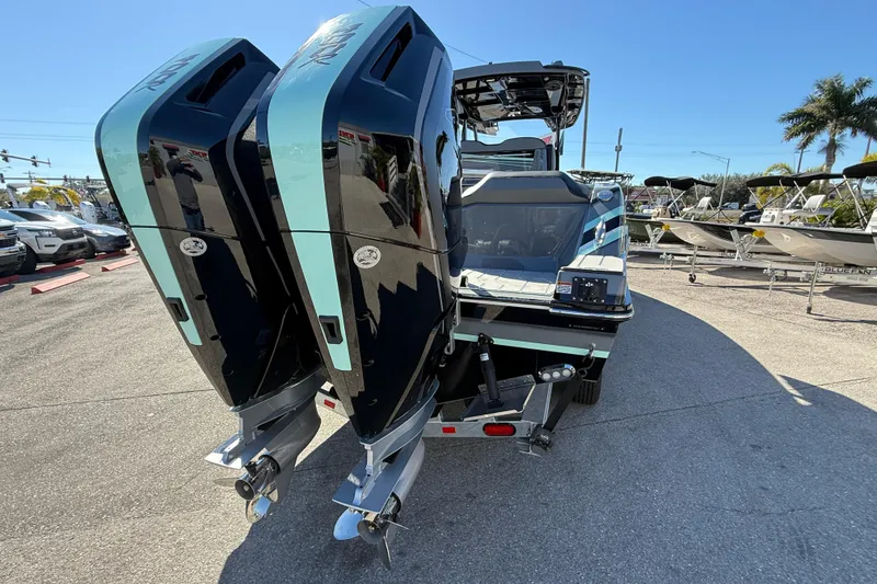 Slide: The Image of 2026 Sunsation 32 CCX boat with dual outboard engines, parked on a trailer. - 7