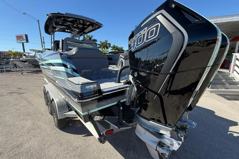 Slide: The Image of 2026 Sunsation 32 CCX boat with powerful outboard engine, parked on a trailer. - 8