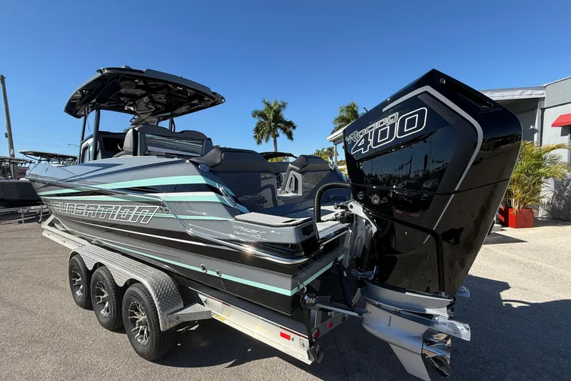 Slide: The Image of 2026 Sunsation 32 CCX boat with Racing 400 engine on a trailer, sunny day. - 9