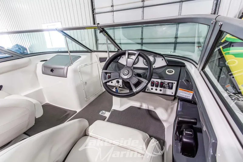 Slide: The Image of 2014 Yamaha Boats SX190 interior with steering wheel and dashboard controls. - 14