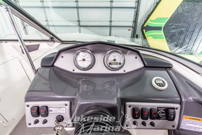 Slide: The Image of Dashboard of 2014 Yamaha Boats SX190 with gauges and controls in a marina setting. - 15