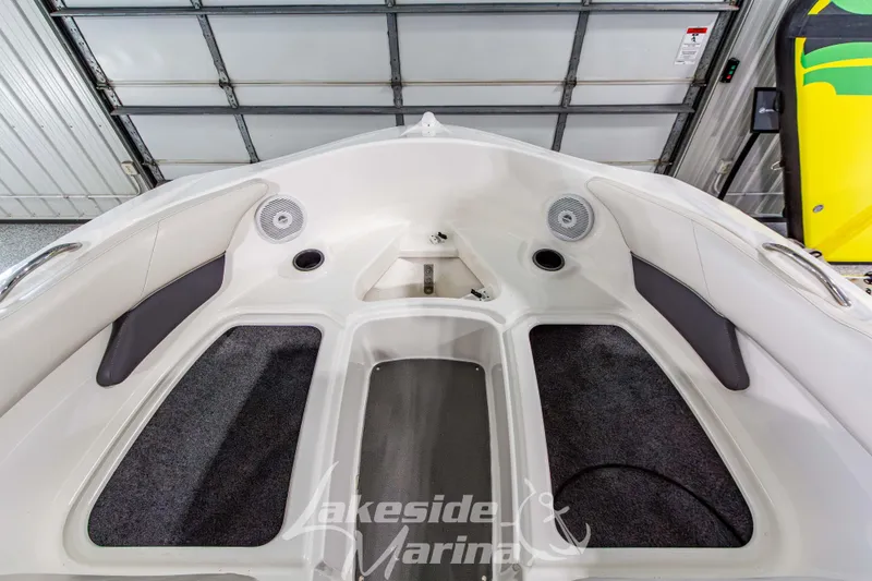 Slide: The Image of 2014 Yamaha Boats SX190 interior with speakers and seating in a garage setting. - 23