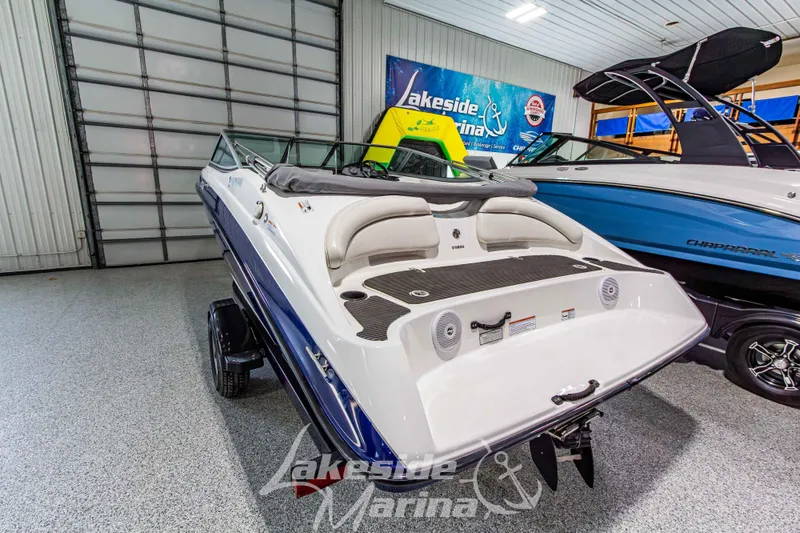 Slide: The Image of 2014 Yamaha Boats SX190 in showroom, rear view, with sleek design and modern features. - 4