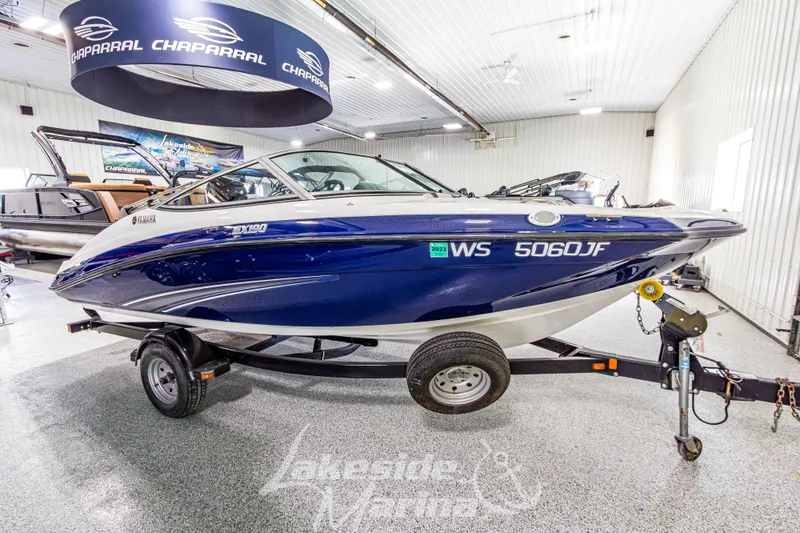 Slide: The Image of 2014 Yamaha Boats SX190 in showroom, blue and white, on trailer. - 7