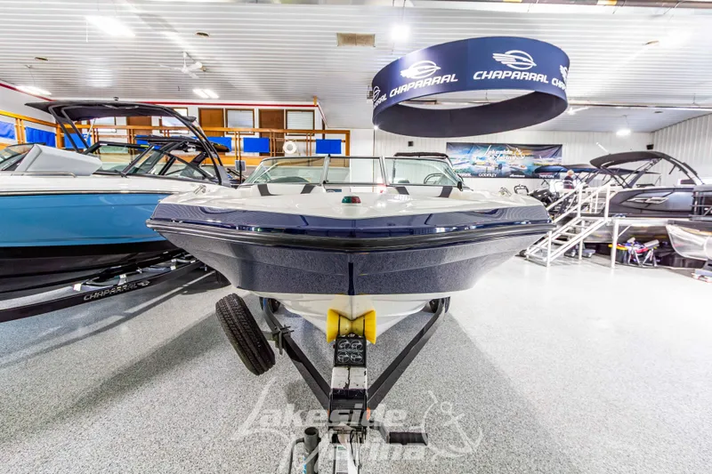 Slide: The Image of 2014 Yamaha Boats SX190 displayed in a showroom with other boats. - 8