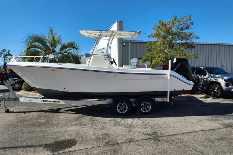 Slide: The Image of 2021 Cobia 237 Center Console boat seat with storage and rod holders. - 13