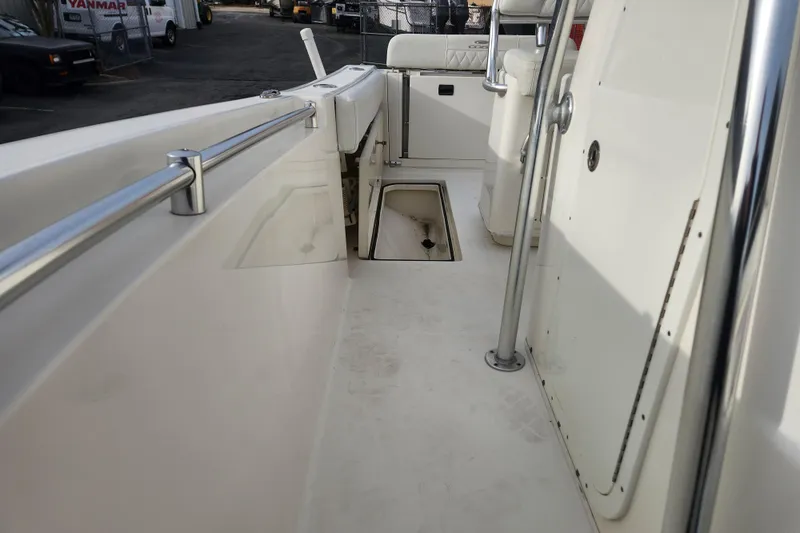 Slide: The Image of 2021 Cobia 237 Center Console boat with open storage compartments and seating area. - 20