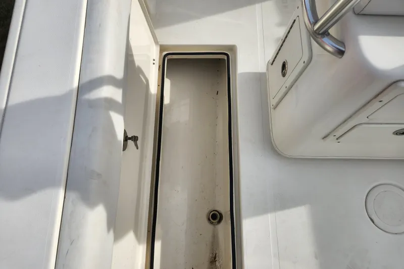 Slide: The Image of Battery compartment of 2021 Cobia 237 Center Console boat, featuring secure battery storage. - 21