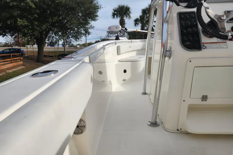 Slide: The Image of 2021 Cobia 237 Center Console boat interior with control panel and seating area. - 6