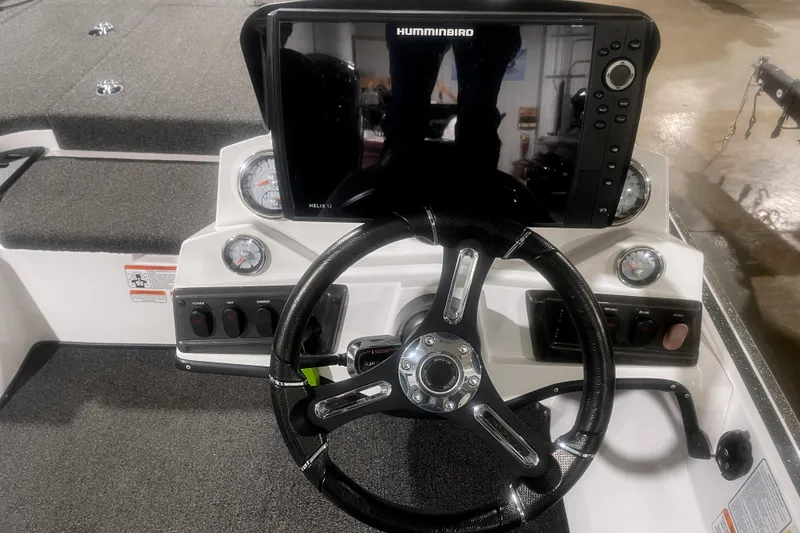 Slide: The Image of 2021 Nitro Z18 boat dashboard with steering wheel and Humminbird Helix 12 display. - 9