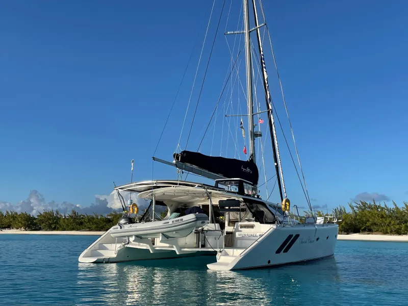 Slide: The Image of 2016 Knysna 500 SE catamaran on calm waters near tropical island. - 31