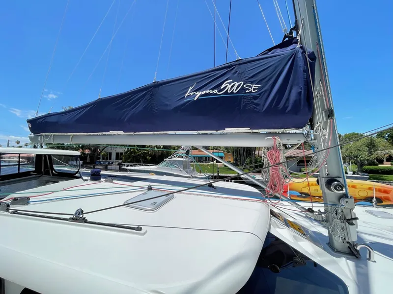 Slide: The Image of Knysna 500 SE sailboat, 2016 model, with blue sail in harbor. - 42